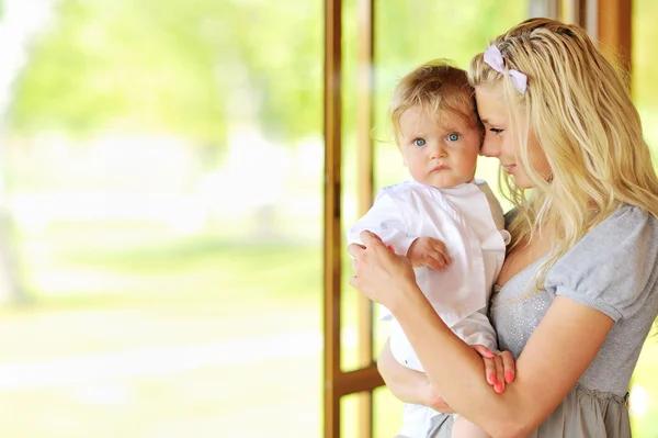 Young mother holding her little baby boy — Stock Photo, Image