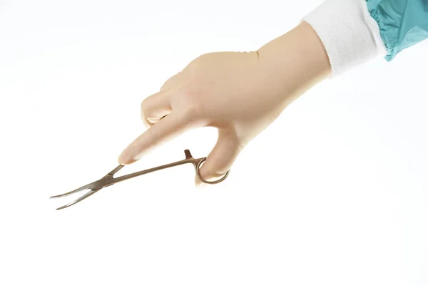 stock image Surgical instrument - curved pean, haemostatic forceps - held by surgeons hand