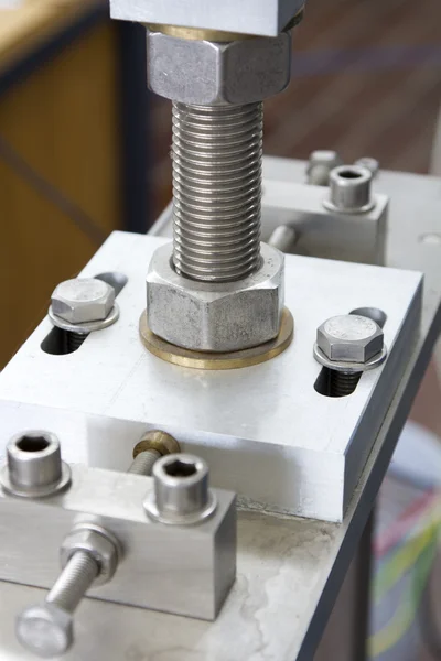 Screws and nuts on CNC machined part - close up — Stock Photo, Image