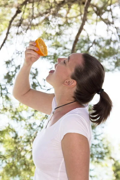 Roztomilá dívka mačkání čerstvý pomeranč — Stock fotografie