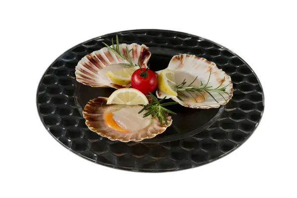 Fresh scallops, served on dark glass plate, isolated on white — Stock Photo, Image