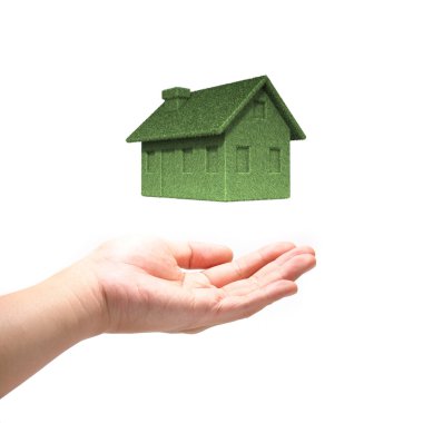 Green Eco house concept with hand isolated on white background clipart