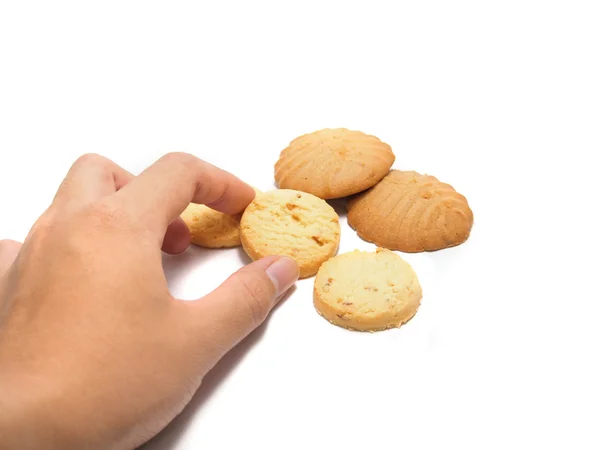 Une main sur le point d'obtenir quelques cookies isolés sur un fond blanc — Photo