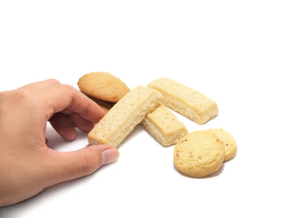 Ruka se dostat nějaké soubory cookie izolovaných na bílém pozadí — Stock fotografie