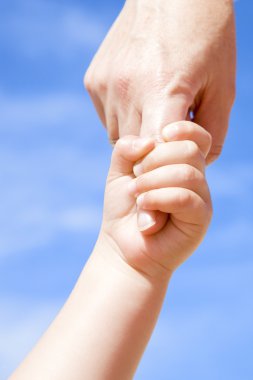 Adult holding a child by the hand clipart