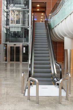 Escalator with elevator at the airport clipart