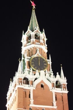 Spasskaya Tower in the dark night at twelve o'clock clipart