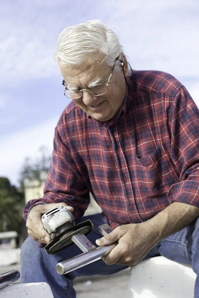 Happy senior man grinding. — Stock Photo, Image