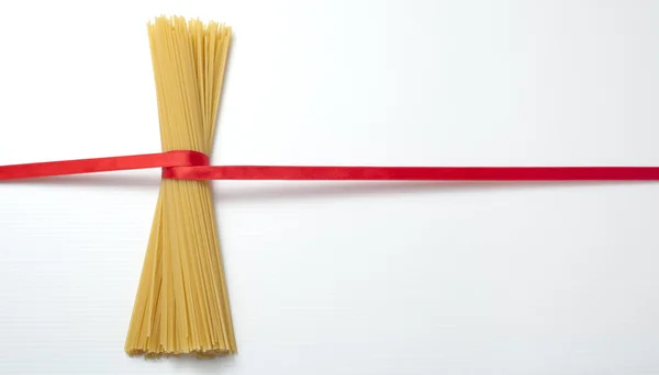 stock image Spaghetti and red ribbon.