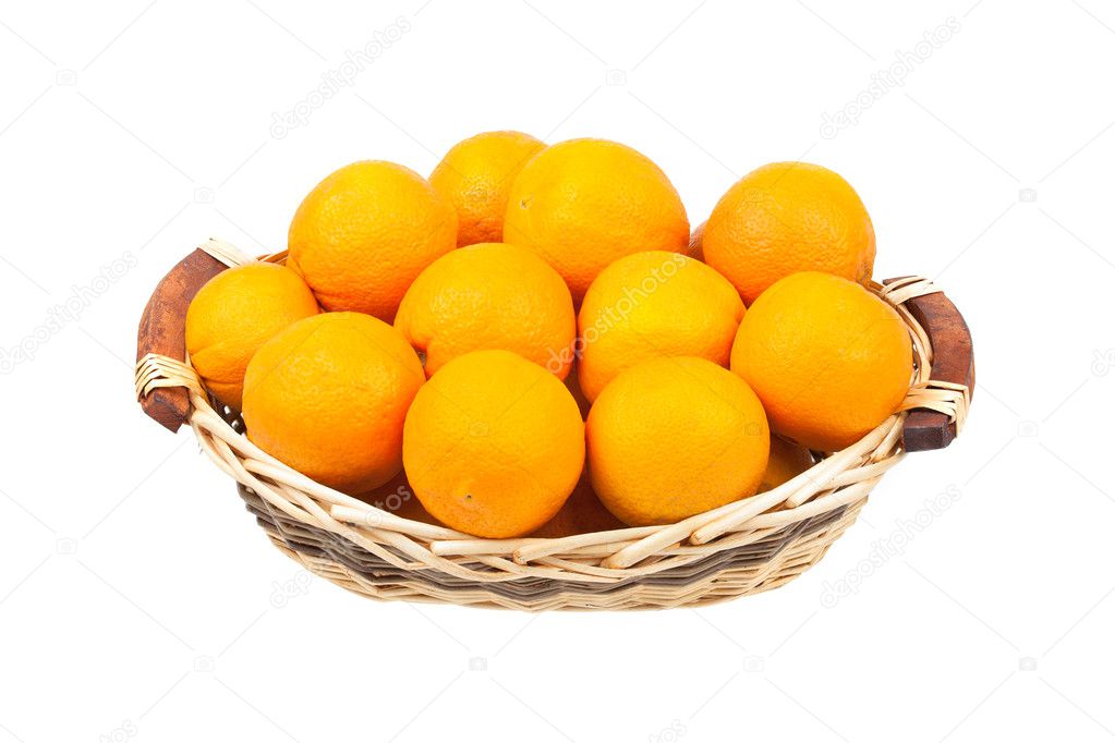 Oranges in a wicker basket isolated on white background