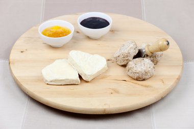 Goat cheese heart shape, sesame seeds, orange and blackberry jam clipart