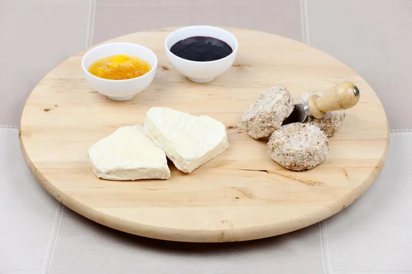 stock image Goat cheese heart shape, sesame seeds, orange and blackberry jam