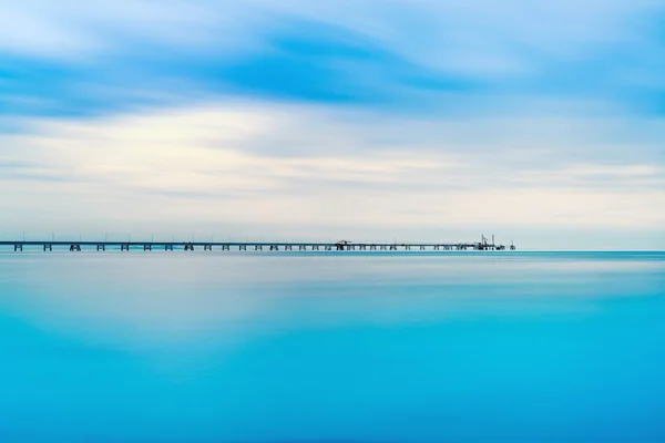 Industrial pier on the sea. Long exposure photography. — Stock Photo, Image