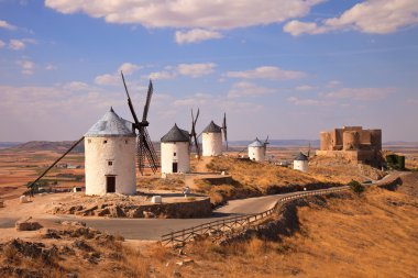 Windmills and castle of Consuegra. Spain clipart