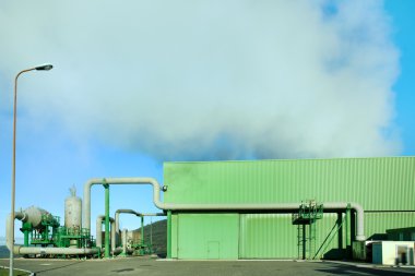 Geothermal energy. A steam coming out from a small green power p clipart