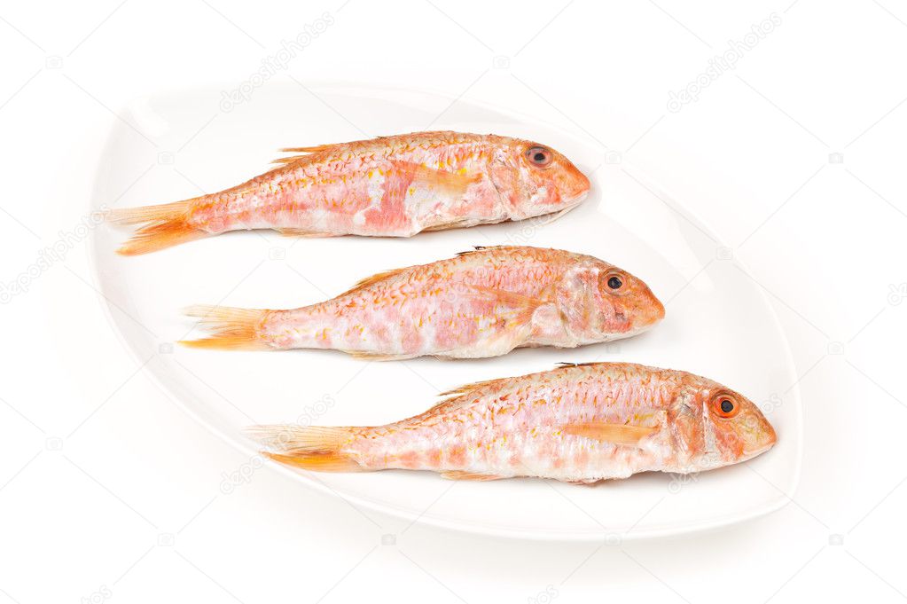 Three Red Mullets seafood on a white oval dish
