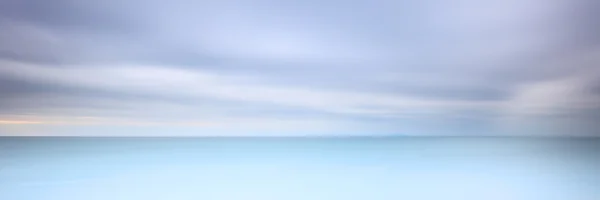 Long exposure photography panorama 3:1 with soft sea and cloudy sky — Stock Photo, Image