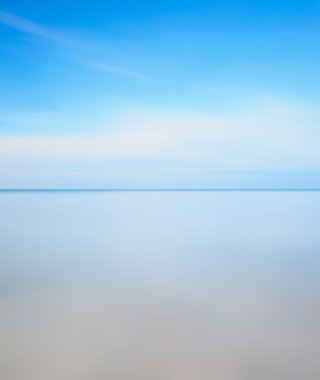 Long exposure photography. Horizon line, soft sea and blue sky clipart