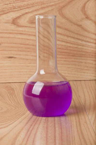Test tube in the laboratory on a wooden background — Stock Photo, Image