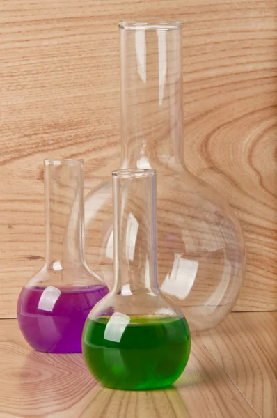 Test tubes in the laboratory on a wooden background — Stock Photo, Image