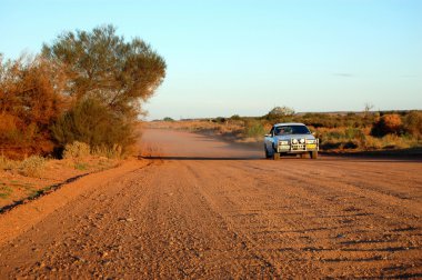 Car at the gravel road clipart