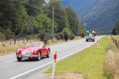 Red retro car on highway clipart