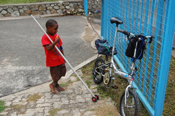 Boy looks on folding bicycle — Stock Photo, Image