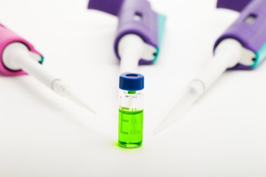 Three pipettes and a vial clipart