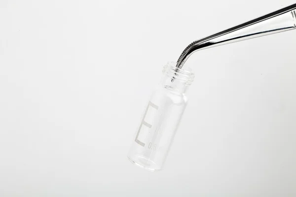 Chromatographic vial and tweezers on white — Stock Photo, Image