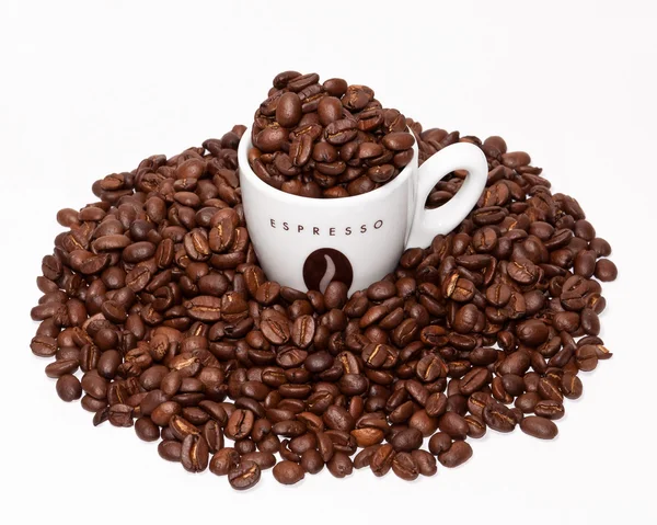 Coffe cup and grouped beans — Stock Photo, Image