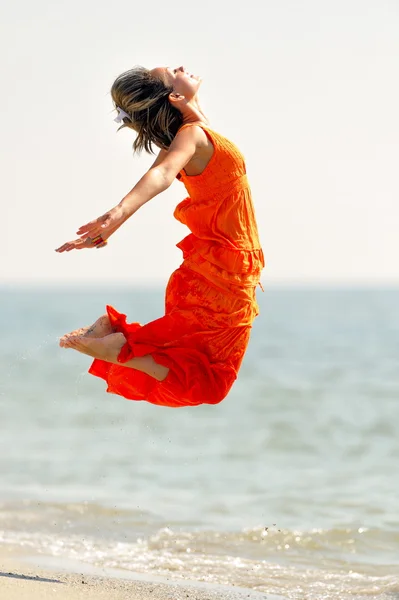 stock image Young woman on the beach in summer