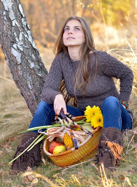 Ung kvinna med grönsaker korg utomhus — Stockfoto