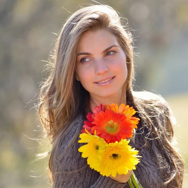 Beautiful girl with colorful flowers — Stock Photo, Image