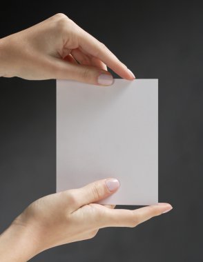 Hands holding white card