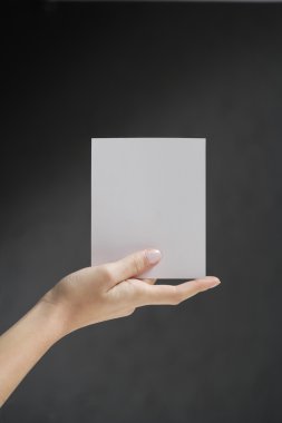 Hands holding white card