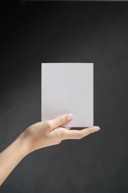 Hands holding white card