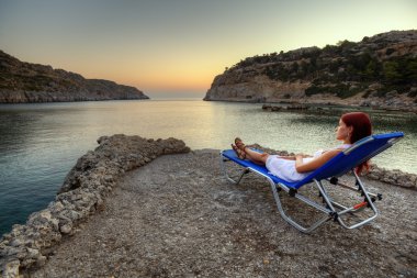 Young woman watching sunrise clipart