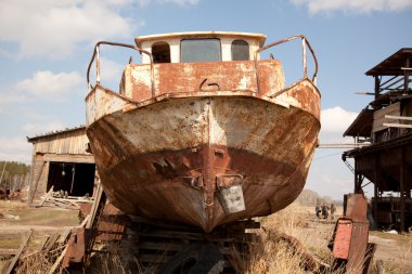 An old rusty ship on dry land