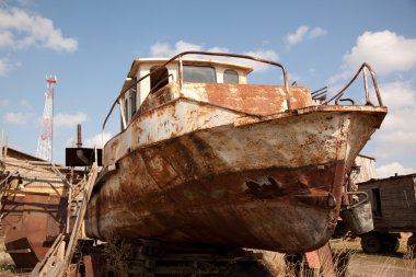 An old rusty ship on dry land