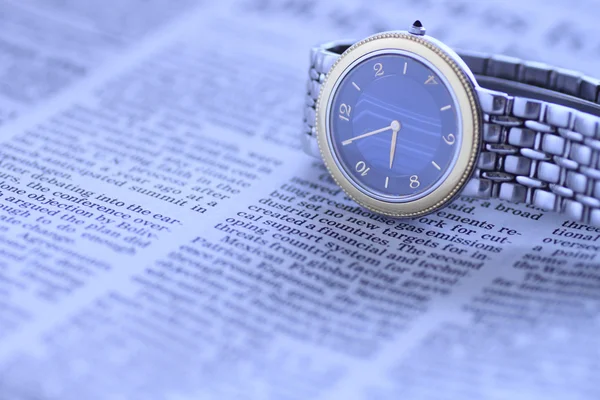 stock image Wrist watch over newspaper