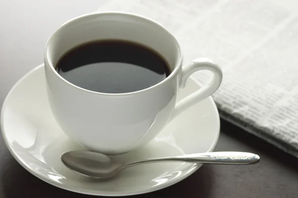 stock image Cup of hot coffee and newspaper