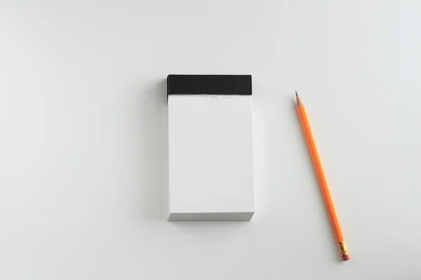 stock image Notepad and pencil on the white background