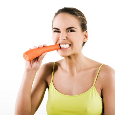 Beautiful brunette caucasian woman on white background biting a carrot clipart