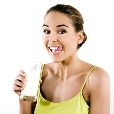 Beautiful brunette caucasian woman on white background holding a glass of milk clipart