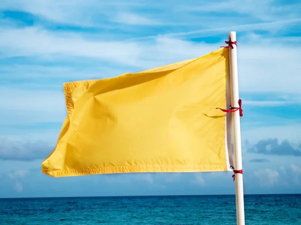 Yellow flag on the sea — Stock Photo, Image