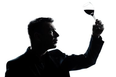 Silhouette man tasting looking at his glass of red wine clipart