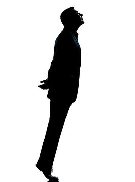 Um homem de negócios silhueta ponta dos pés olhando para cima — Fotografia de Stock