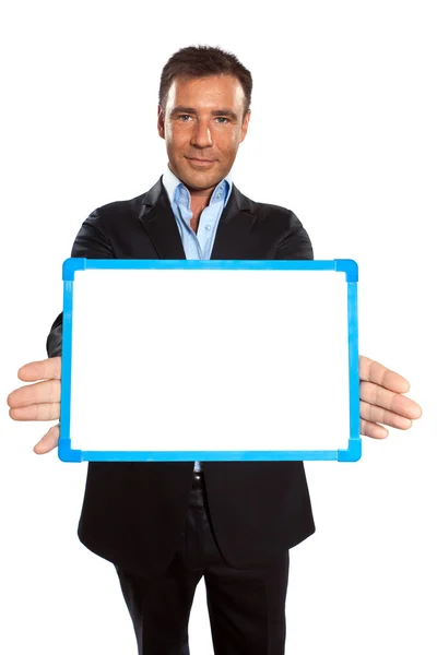 Um homem de negócios segurando mostrando quadro branco — Fotografia de Stock