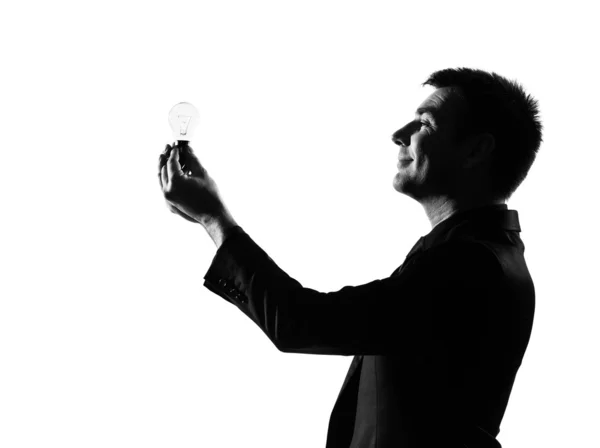 Homem silhueta segurando lâmpada — Fotografia de Stock