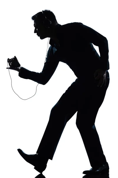 Homem silhueta de comprimento inteiro dançando feliz ouvir música — Fotografia de Stock